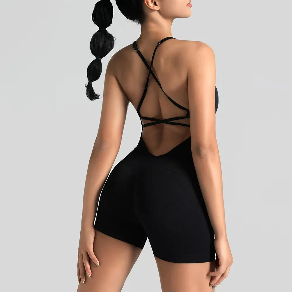 Woman wearing a black strappy outfit on a gray background