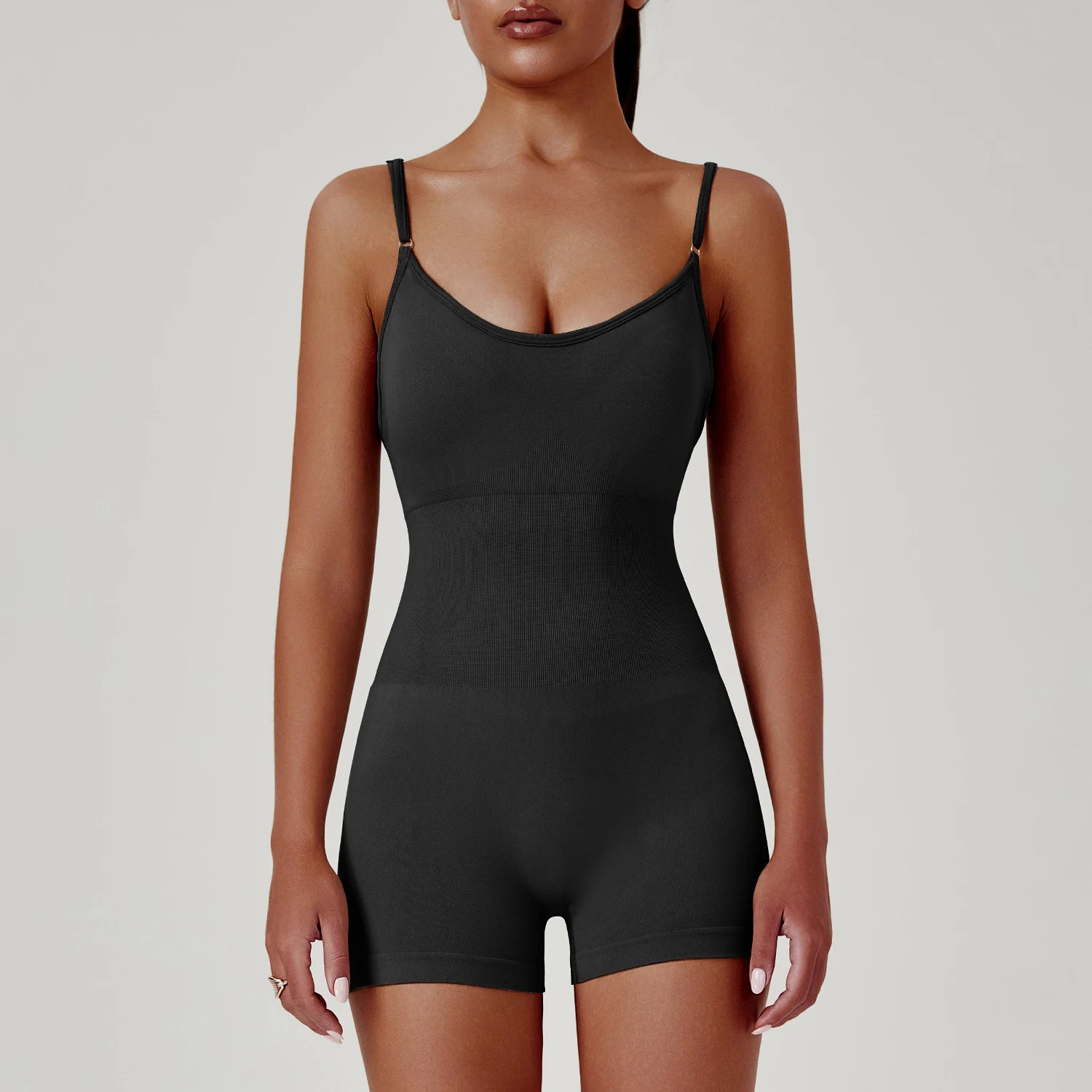 Black shapewear bodysuit worn by a model on a plain background
