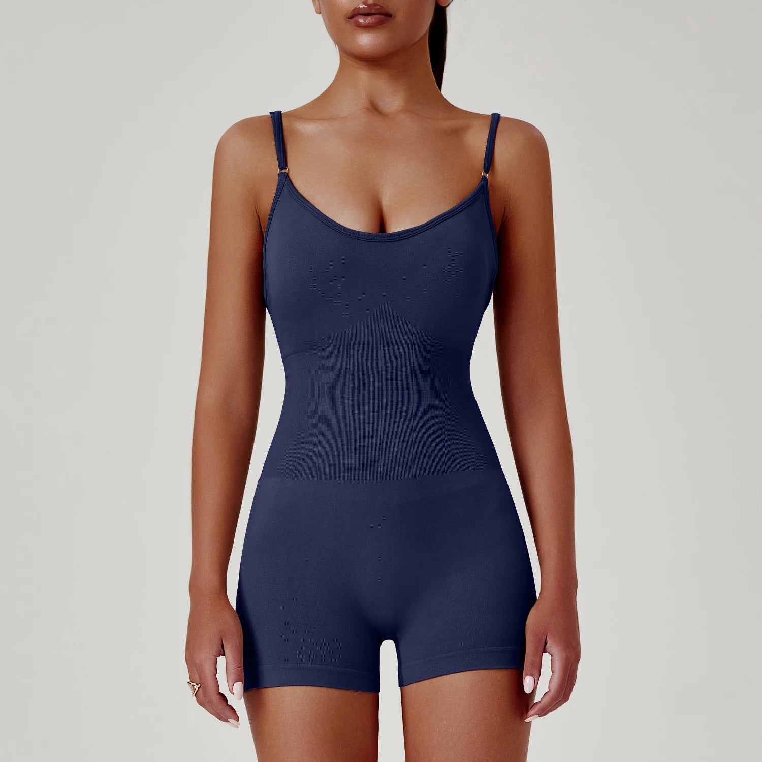 Navy blue bodysuit worn by a model on a plain background
