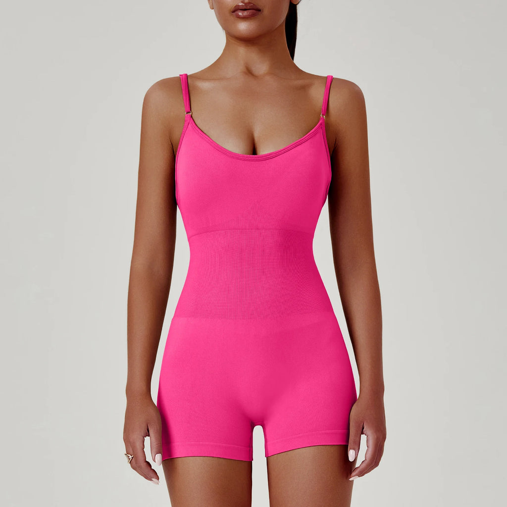 Person wearing a bright pink bodysuit against a plain background