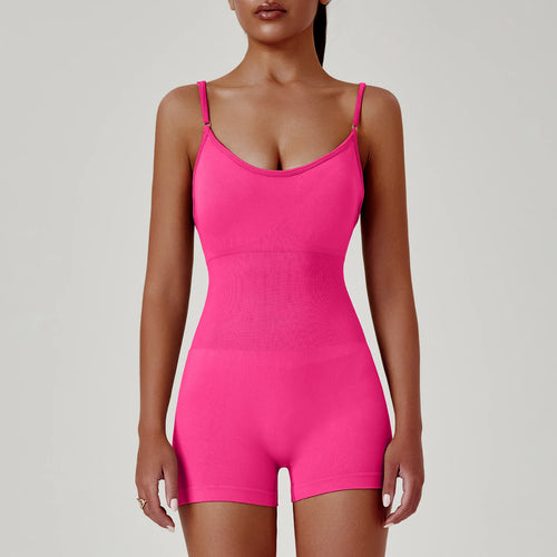 Person wearing a bright pink bodysuit against a plain background